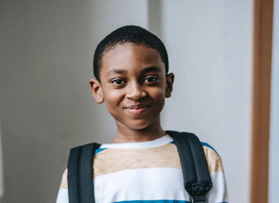 child with backpack on